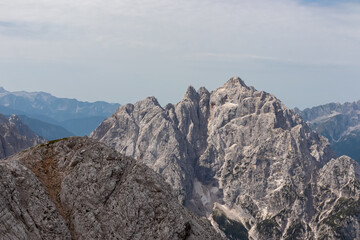 Panoramic view of rugged mountain ridge Prisank in majestic Julian Alps seen from top of summit...