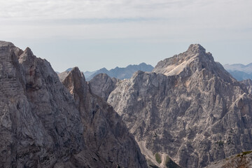 Panoramic view of rugged mountain ridge Mangart in majestic Julian Alps seen from top of summit...