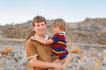 Father and son traveling through West of USA in Grand Canyon. Happy little child and young man. Dad...