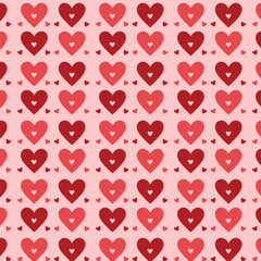 Seamless pattern with red hearts on a pale orange background