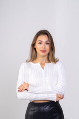 Close-up portrait of attractive brunette young woman standing on a white background. Copy space