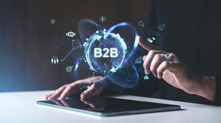 Digital B2B visualization with holographic icons over tablet screen, emphasizing networking, technology, and business strategies.