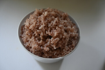 a bowl of riceberry rice : close-up pile of rice called riceberry rice, rice with high nutrients on white background. purple rice.