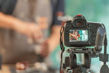Man is holding a cell phone up to his face, taking a picture of something