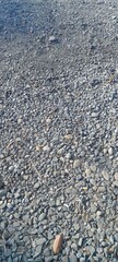 A stretch of gravel along the side of the road