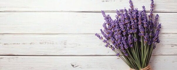 A vibrant bouquet of lavender rests on a rustic wooden surface, showcasing its delicate purple...