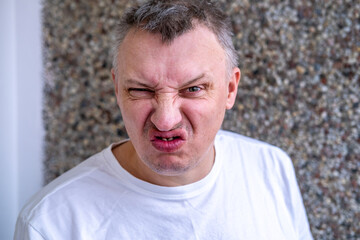 distorted face of sad and grieved very upset person, dissatisfied with his hard fate