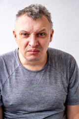 distorted face of sad and grieved very upset person, dissatisfied with his hard fate