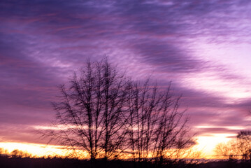 Fototapeta premium colorful sunrise sky outside the window, colorful play of light, shadows and reflections on the window glass, blurred outlines