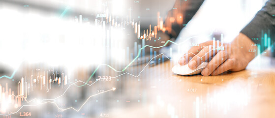 Financial data overlay with candlestick chart and graphs on blurred background of hand using computer mouse. Concept of digital trading.