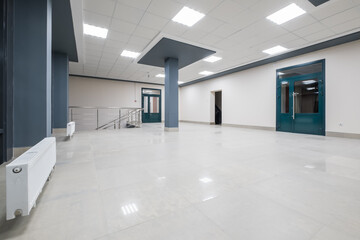 panorama view in empty modern hall with columns, doors and panoramic windows at night