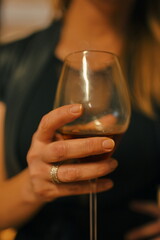 Midsection of woman holding glass with drink