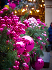 Christmas card with a tree, large pink Christmas balls and bright lanterns
