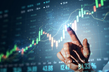 Hand interacting with a glowing financial chart on digital interface in a blue gradient background.