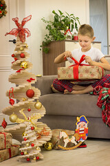 child decorating christmas tree