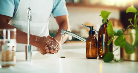 Kitchen, foam and washing hands for hygiene, health and wellness for virus, infection and prevention. Person, cleaning and routine with water, soap and self care for bacteria, germs and dirt in home
