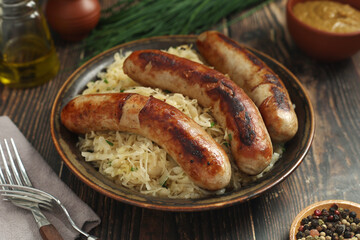 A bowl with Bratwurst and Sauerkraut as side dish - traditional German food