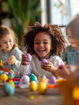 Joyful children painting easter eggs together in a sunny room