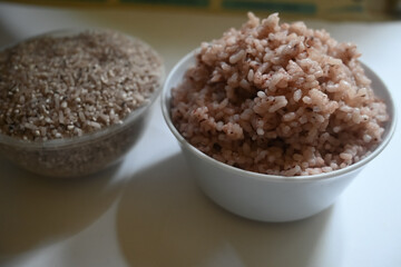 a bowl of riceberry rice : close-up pile of rice called riceberry rice, rice with high nutrients on white background. purple rice.