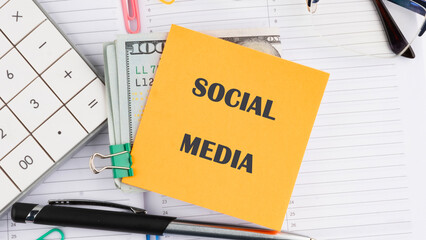 Posters and social media. The conceptual text of SOCIAL MEDIA it is written on a sticker on the background of an open notebook