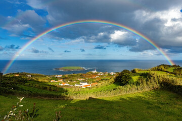 Breathtaking view of the amall village and lighthouse at São Jorge island in Azores with huge...