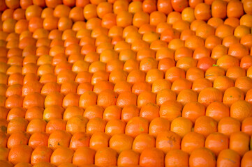 a large display of oranges for sale at a fruit stand.