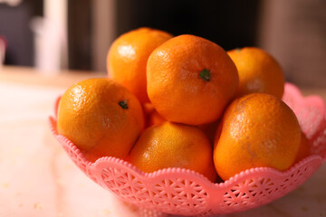 Tangerines in a vase on the kitchen table