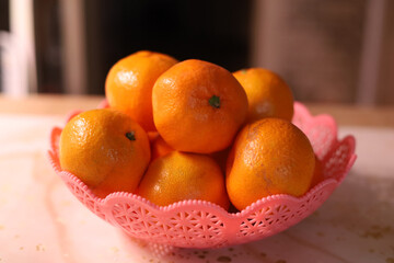 Tangerines in a vase on the kitchen table