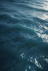 Naklejka premium Silky smooth surface of the ocean in a soothing blue hue with gentle ripples and waves, gradient, ruffled surface , blue water