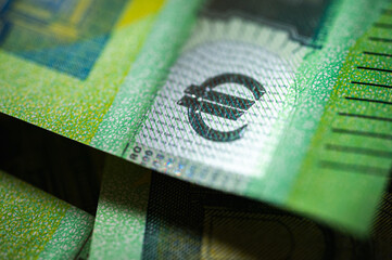 Obraz premium Close-up of a crisp 100 euro bill showing security elements and intricate design. Useful for themes like money, wealth, finance, banking, and European currency