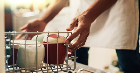 Hands, person and washing dishes at house with dishwasher, dirty utensils and loading machine of hygiene. Cleaner, technology and crockery for household chores, disinfectant routine and domestic task