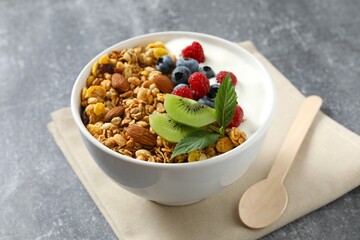 Delicious granola with berries and yogurt on a light background
