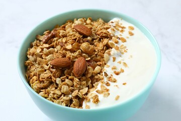 Delicious granola with berries and yogurt on a light background