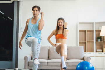 Obraz premium Asian healthy couple workout at home, exercise, fit, doing yoga, home fitness concept.