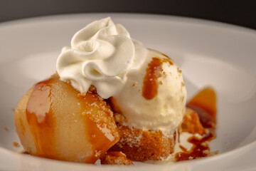 Ice Cream Dessert with pear on a white plate on table