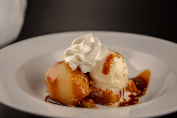 Ice Cream Dessert with pear on a white plate on table