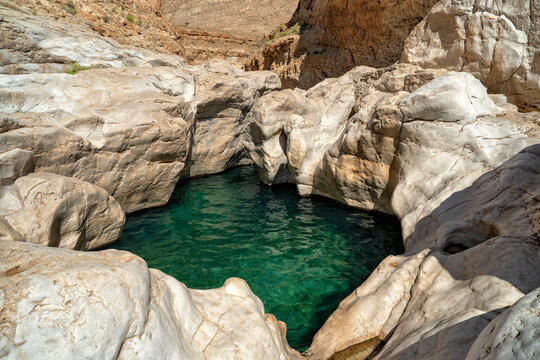 Oman. Oasis Wadi Bani Khalid. Lagoon with fresh emerald water and beautiful rocks