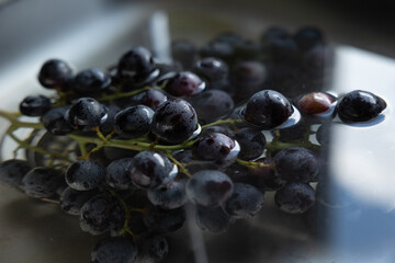 Grapes in the kitchen sink. Grapes are cleaned of dust and dirt.