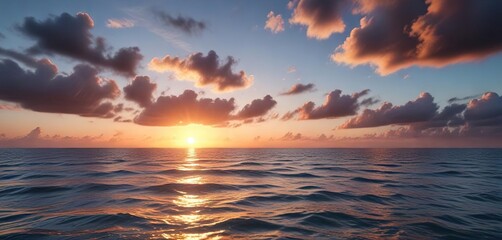 Calm ocean waters at sunset with a few clouds, clear water, peaceful evening