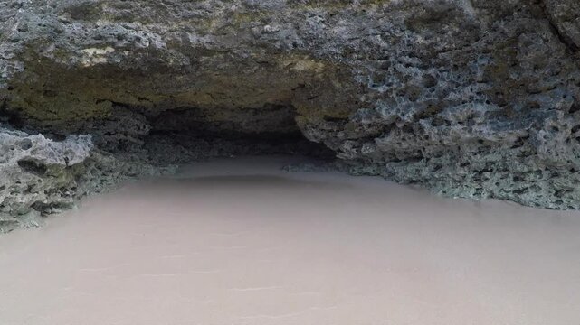 The cave on the rocks of the secret beach near Pantai Tegal Wangi, Bali, Indonesia