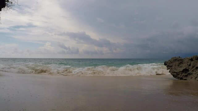 Stormy sky over rocks of the secret beach near Pantai Tegal Wangi, Bali, Indonesia