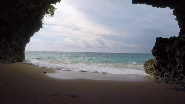 Stormy sky over rocks of the secret beach near Pantai Tegal Wangi, Bali, Indonesia