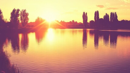 Sunset over calm lake with silhouetted trees