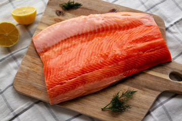 Organic Raw Salmon Fillet on a wooden board, top view. Flat lay, overhead, from above.