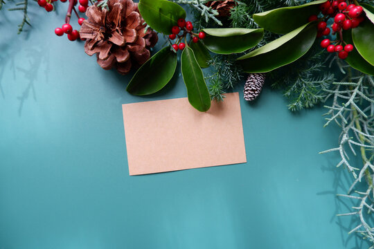 winter holiday natural leaves, berries and pine cone decoration background. winter holiday and Merry Christmas decorative background with greeting card.