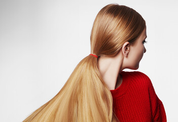 Woman with Straight Blond Hair, Tied in Ponytail, Wearing Red Knitted Pullover. Beautiful Gold Hair in Pony Tail