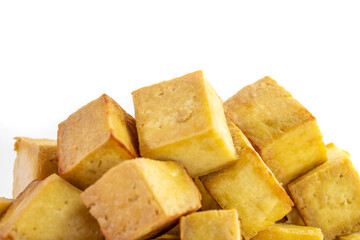 Fried tofu cubes on a plate with chopsticks. organic vegetarian tofu.  soy beans.Vegan food ingredient in Asian cuisine, Plant based diet. food concept.. Chinese food