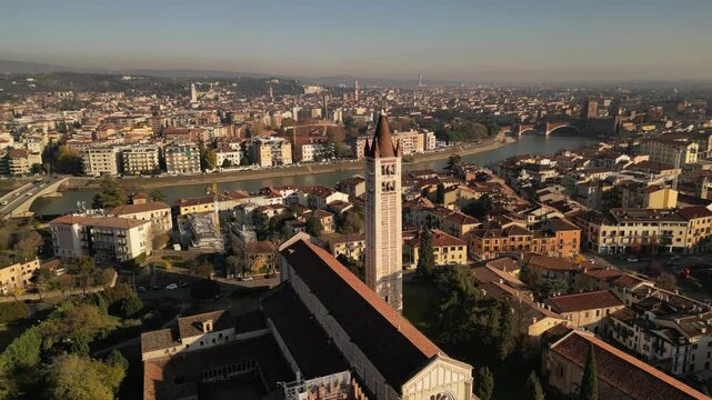 drone aerial video of historical unesco heritage Italian Verona San Zeno church with chapel on piazza in sunny day 