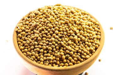Organic soy beans falling into a rustic wicker bowl. Raw dried soya grains. Healthy legume ingredient. Rotation. Food