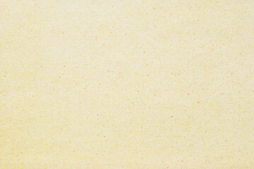 A sheet of spotted yellow recycled craft paper texture as background